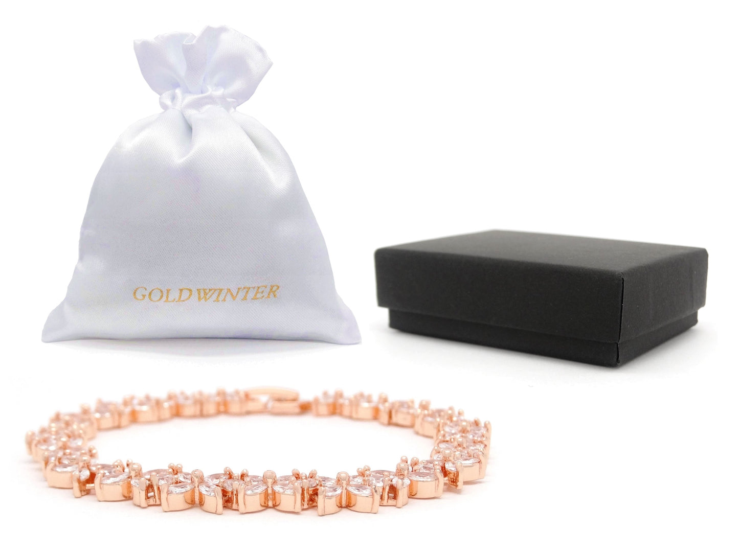 Rose gold necklace with a white drawstring bag and black jewelry box on a white background