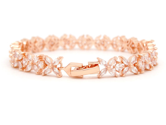 Rose gold bracelet with floral design on a white background