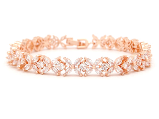 Rose gold bracelet with clear stones on a white background
