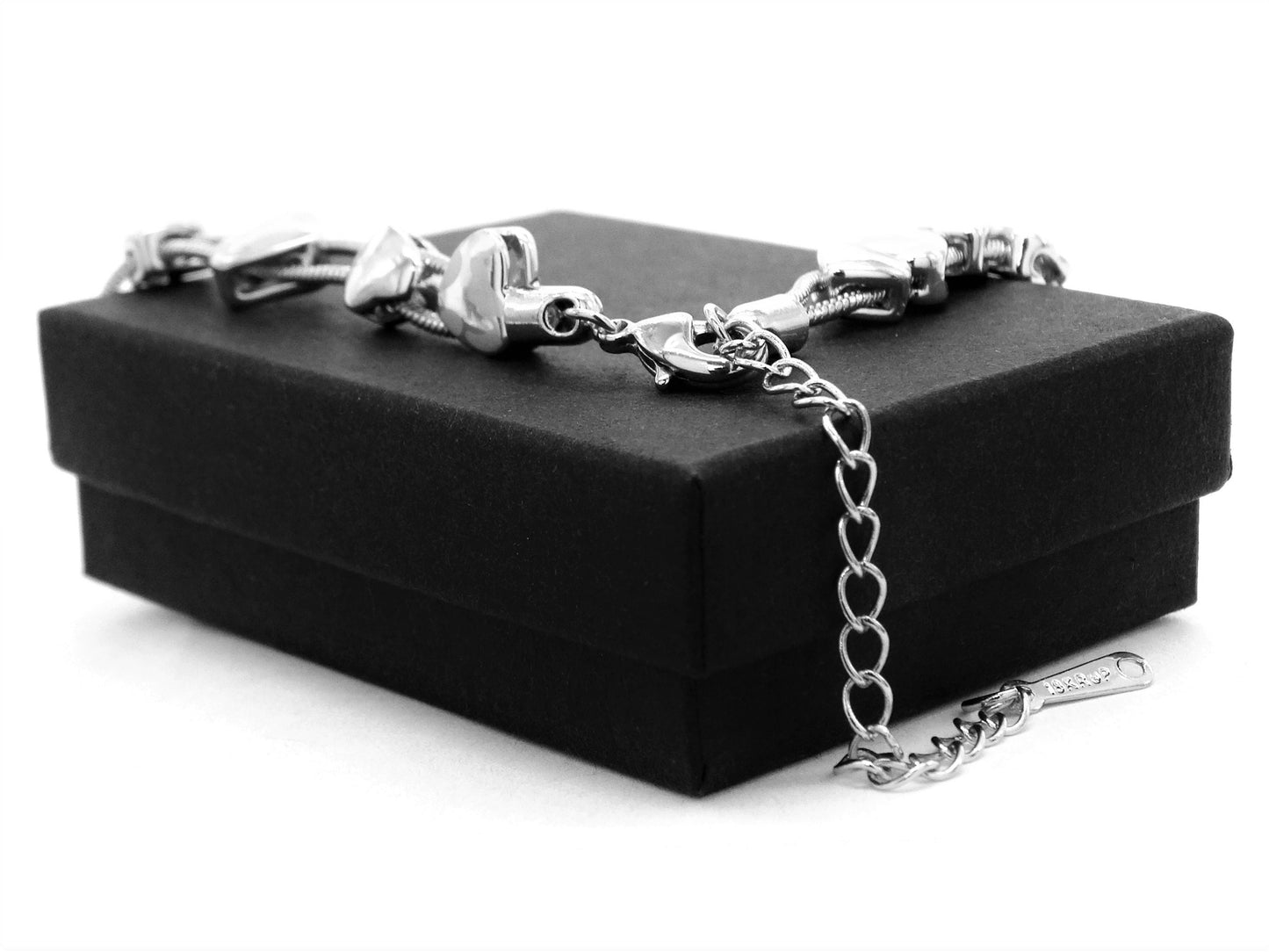 Silver bracelet with chain on a black jewelry box