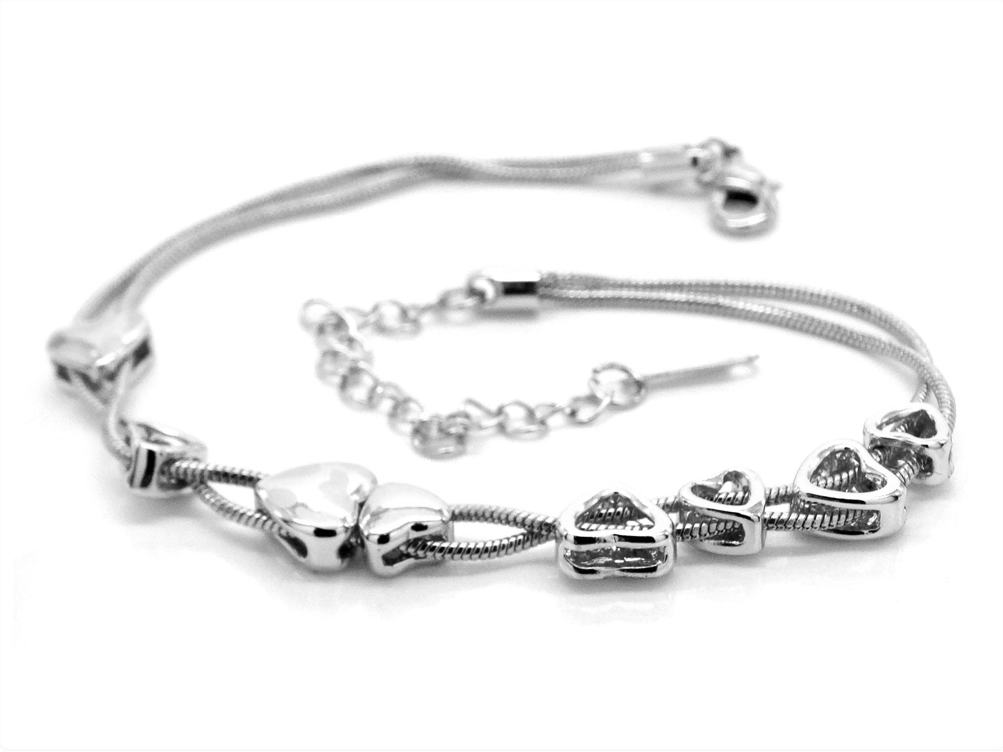 Silver bracelet with heart-shaped charms on a white background