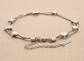 White Gold Snake Chain Bracelet With Heart Charms