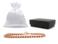 Rose gold chain necklace with a white drawstring bag and black box on a white background
