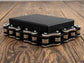 Black jewellery box with steel bike chain on a wooden surface